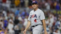 USA manager Mark DeRosa (4) returns to the dugout after a pitching change during the fifth inning against Venezuela at LoanDepot Park.