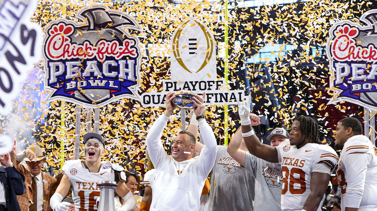 Texas players, including Kelvin Banks Jr., celebrating with Steve Sarkisian.