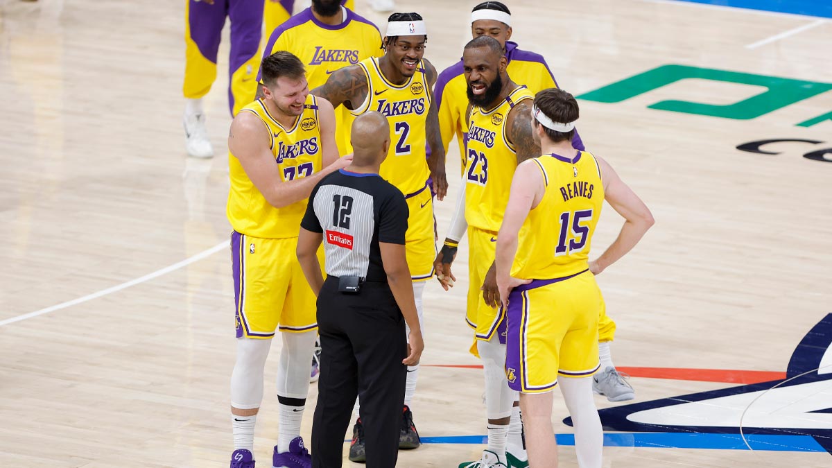 Los Angeles Lakers guard Luka Doncic (77), forward Jarred Vanderbilt (2), forward LeBron James (23), and guard Austin Reaves (15) talk to an official during a time out in the second half of a game against the Oklahoma City Thunder at Paycom Center.