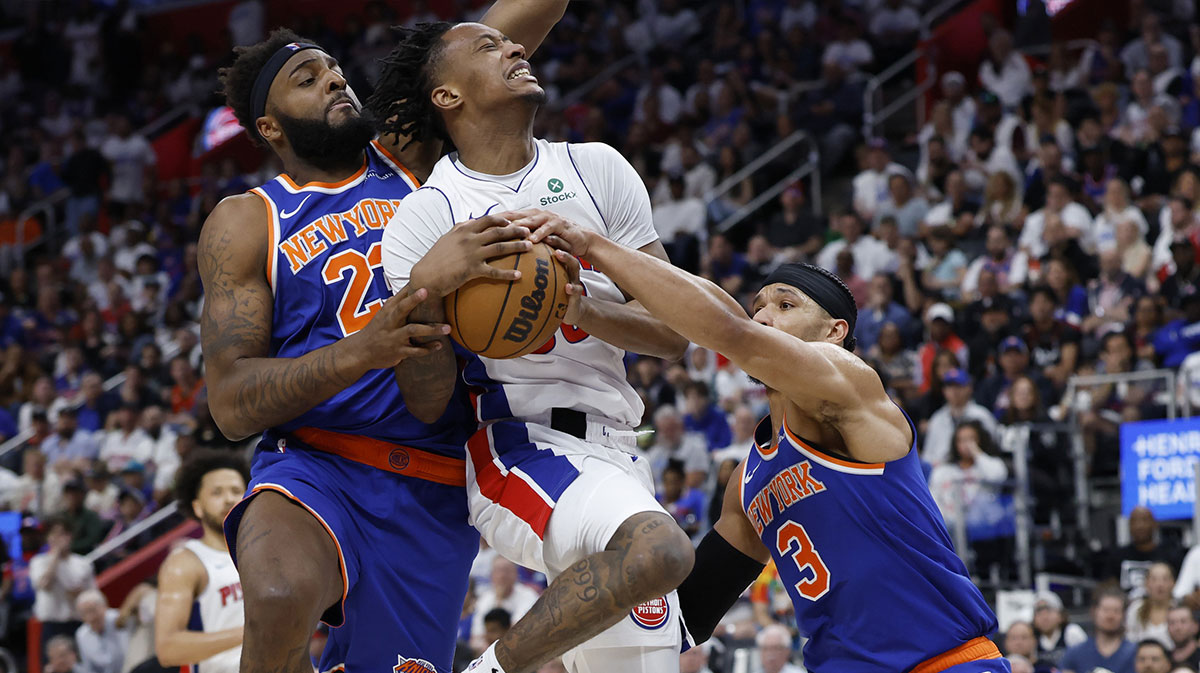 Detroit Pistons forward Ronald Holland II (00) is defended by New York Knicks center Mitchell Robinson (23) and guard Josh Hart (3) in the second half during game three of first round for the 2024 NBA Playoffs at Little Caesars Arena.