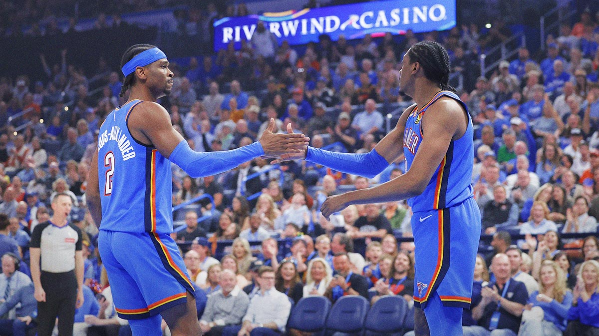 Thunder guard Shai Gilgeous-Alexander (2) and forward Jalen Williams (8) high five after a play against the Detroit Pistons during the first quarter at Paycom Center