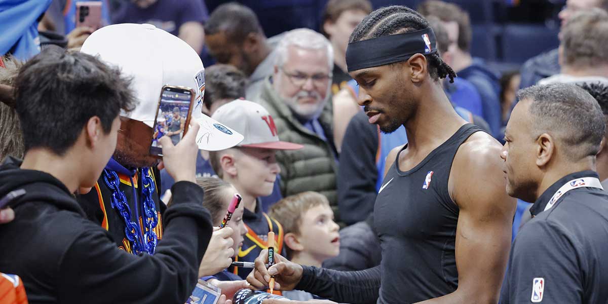 Thunder guard Shai Gilgeous-Alexander (2) interacts with fans before the start of a game against the Los Angeles Lakers at Paycom Center