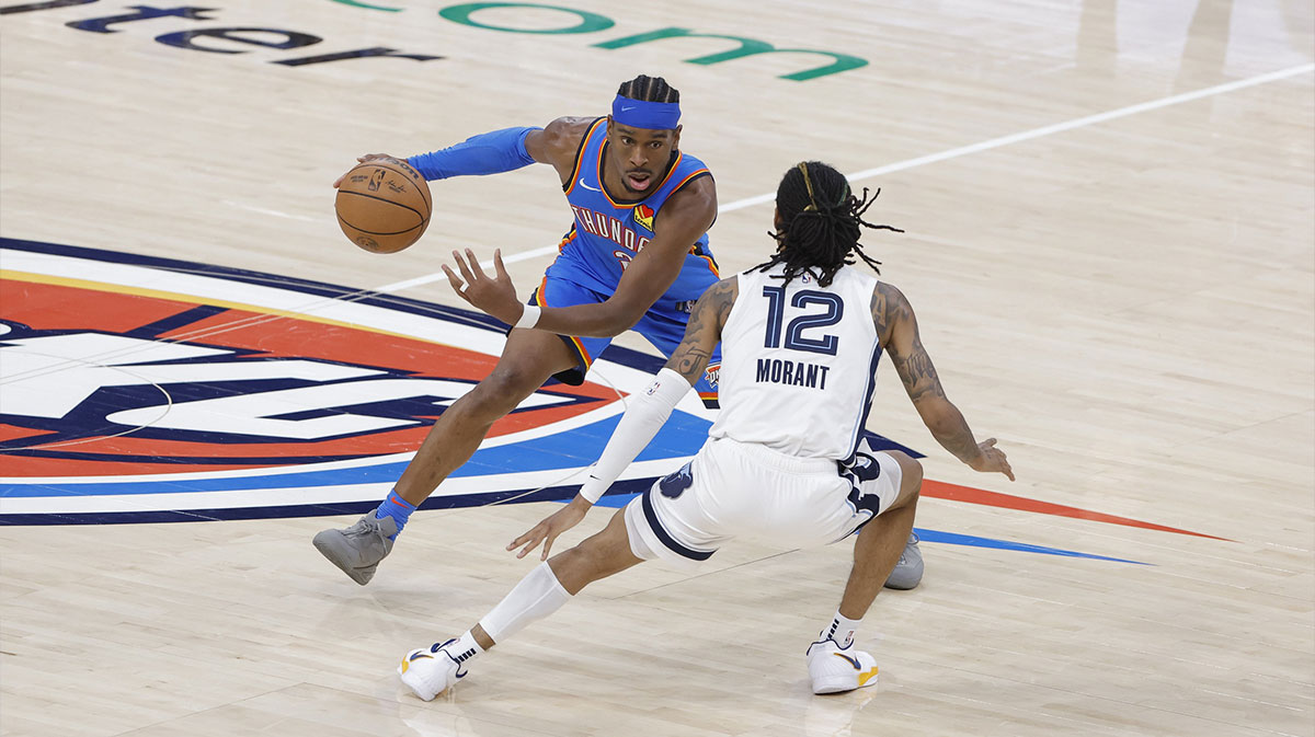 Thunder guard Shai Gilgeous-Alexander (2) moves the ball against Memphis Grizzlies guard Ja Morant (12) in the fourth quarter during game two of first round for the 2024 NBA Playoffs at Paycom Center