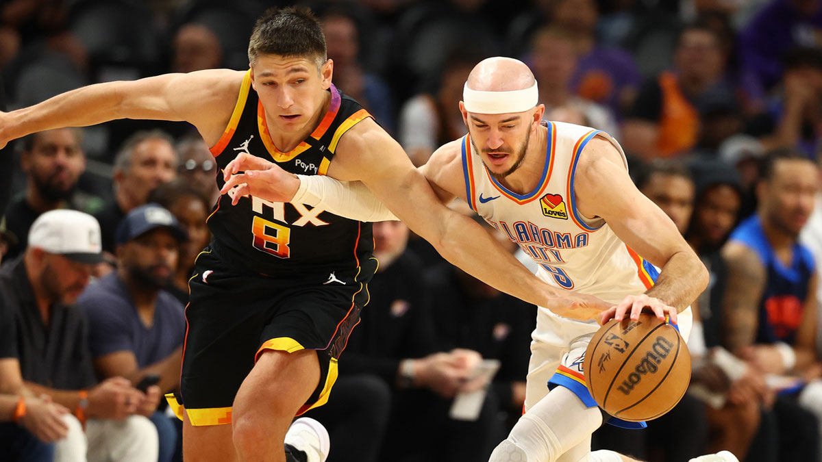 Apr 9, 2025; Phoenix, Arizona, USA; Oklahoma City Thunder guard Alex Caruso (9) and Phoenix Suns guard Grayson Allen (8) attempt to get a ball during the second half at Footprint Center. Mandatory Credit: Mark J. Rebilas-Imagn Images
