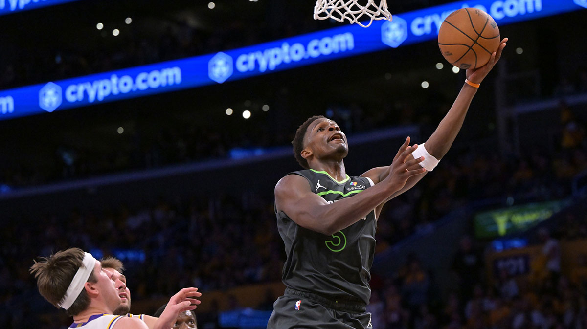 Minnesota Timberwolves guard Anthony Edwards (5) drives past Los Angeles Lakers guard Austin Reaves (15) in the second half at Crypto.com Arena.