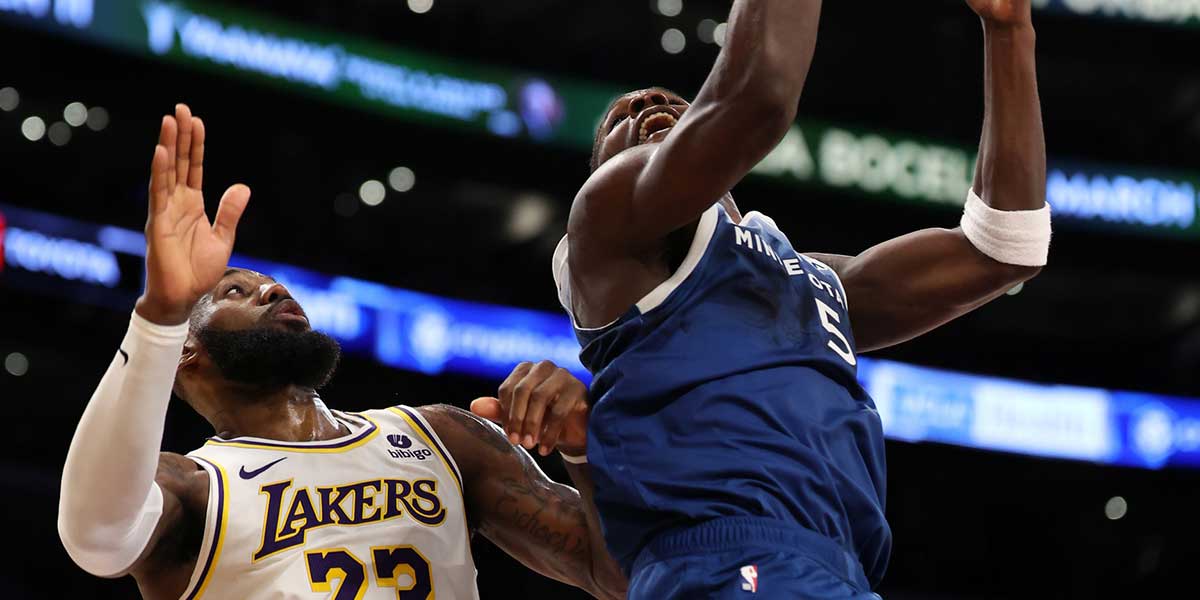 Minnesota Timberwolves guard Anthony Edwards (5) shoots the ball against Los Angeles Lakers forward LeBron James (23) during the fourth quarter at Crypto.com Arena.
