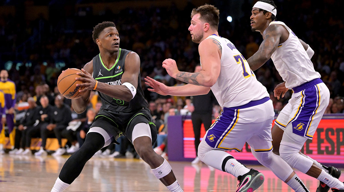 Minnesota Timberwolves guard Anthony Edwards (5) is defended by Los Angeles Lakers guard Luka Doncic (77) in the second half at Crypto.com Arena.