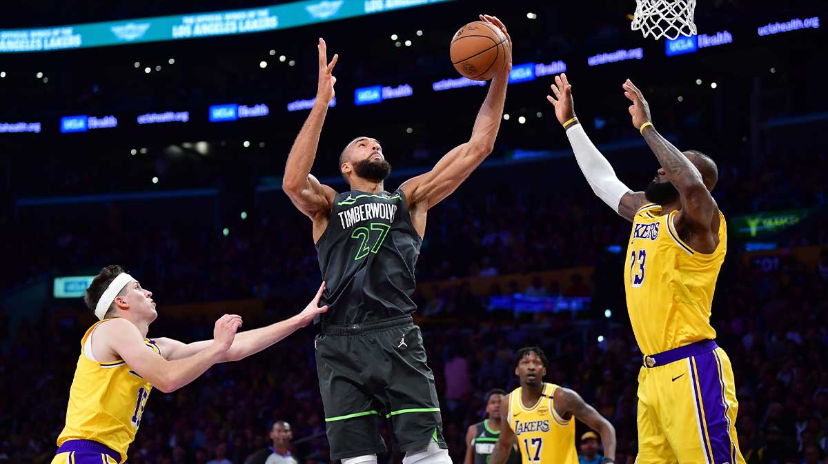 Minnesota Timberwolves center Rudy Gobert (27) gets the rebound against Los Angeles Lakers guard Austin Reaves (15) and forward LeBron James (23) during the second half in game five of first round for the 2025 NBA Playoffs at Crypto.com Arena.