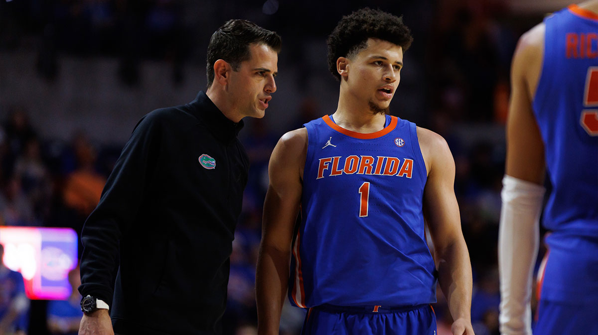 Florida Gators head coach Todd Golden talks with Florida Gators guard Walter Clayton Jr. (1) during a free throw against the Texas Longhorns during the first half at Exactech Arena at the Stephen C. O'Connell Center.