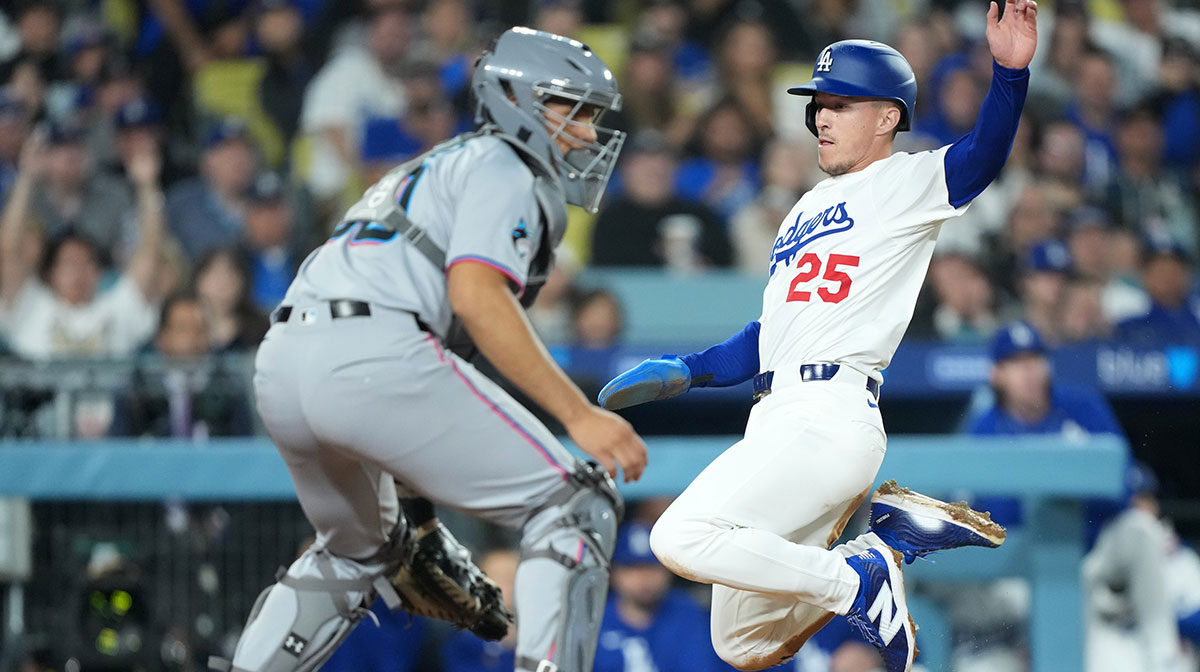 Los Angeles Dodgers second baseman Tommy Edman (25) scores against Miami Marlins catcher Agustin Ramirez (50) during the third inning at Dodger Stadium. Mandatory Credit: Kirby Lee-Imagn Images