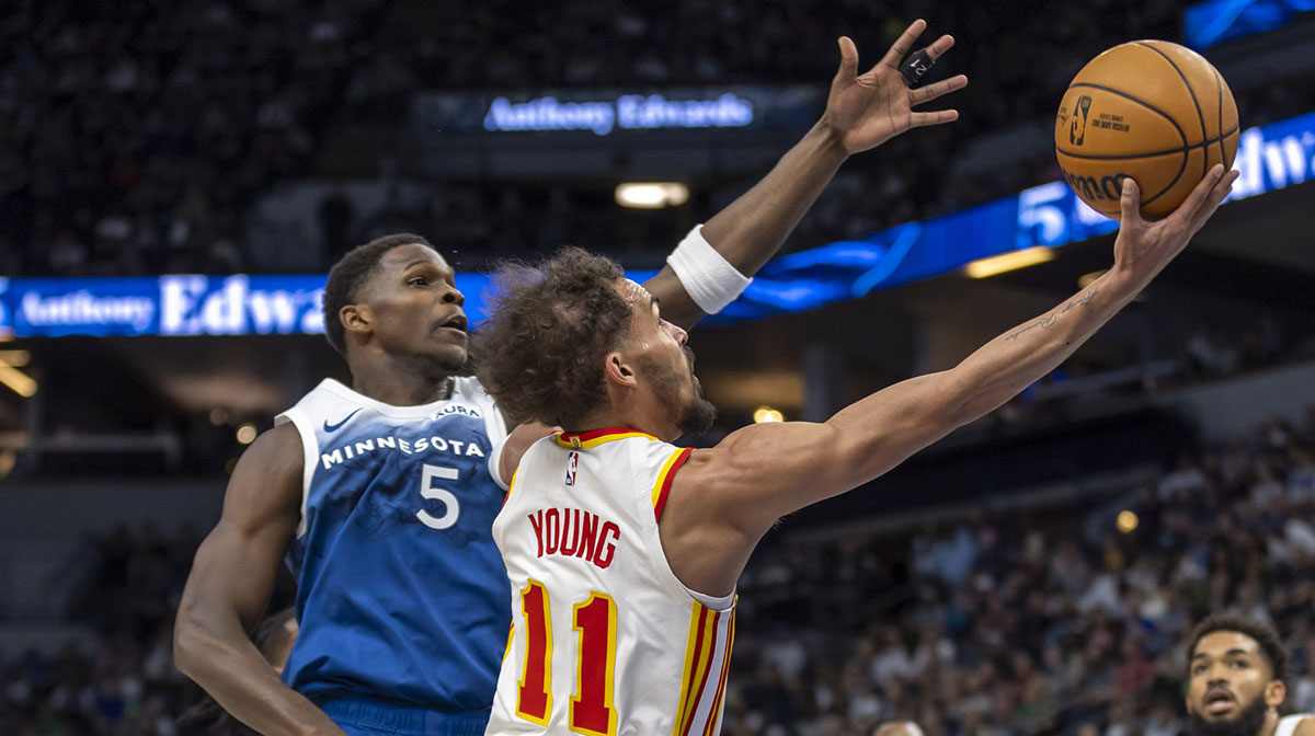 Atlanta Hawks guard Trae Young (11) drives to the basket past Minnesota Timberwolves guard Anthony Edwards (5) in the first half at Target Center.