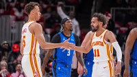 Atlanta Hawks guard Dyson Daniels (5) and guard Trae Young (11) react after combining for a basket against the Orlando Magic during the first half at State Farm Arena.