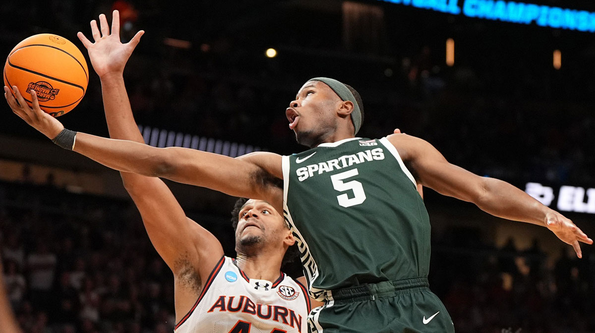 Michigan State Spartans guard Tre Holloman (5) shoots against Auburn Tigers center Dylan Cardwell (44) during the first half in the South Regional final of the 2025 NCAA tournament at State Farm Arena in college basketball transfer portal.
