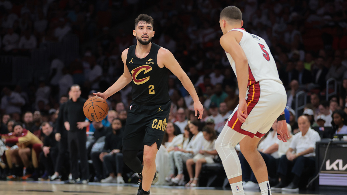 Cleveland Cavaliers guard Ty Jerome (2) dribbles the basketball as Miami Heat forward Nikola Jovic (5) defends in the first quarter during game three for the first round of the 2025 NBA Playoffs at Kaseya Center.