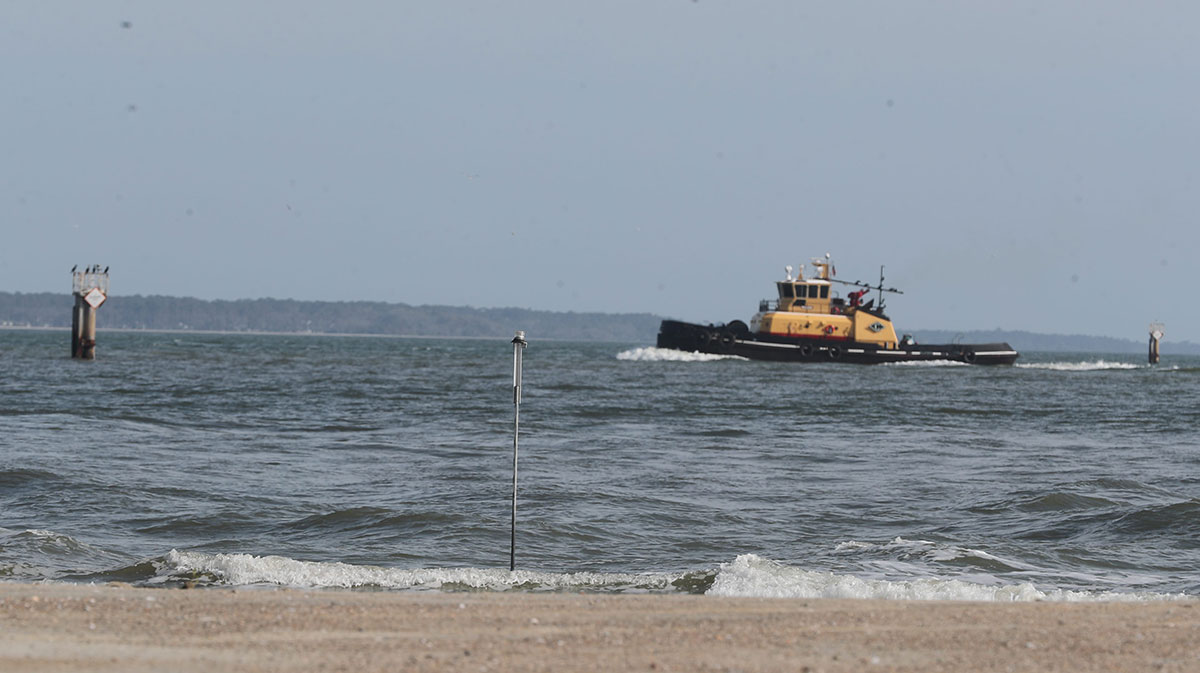 A pole in the edge of the water marks a sensor position for the US Army Corps of Engineers