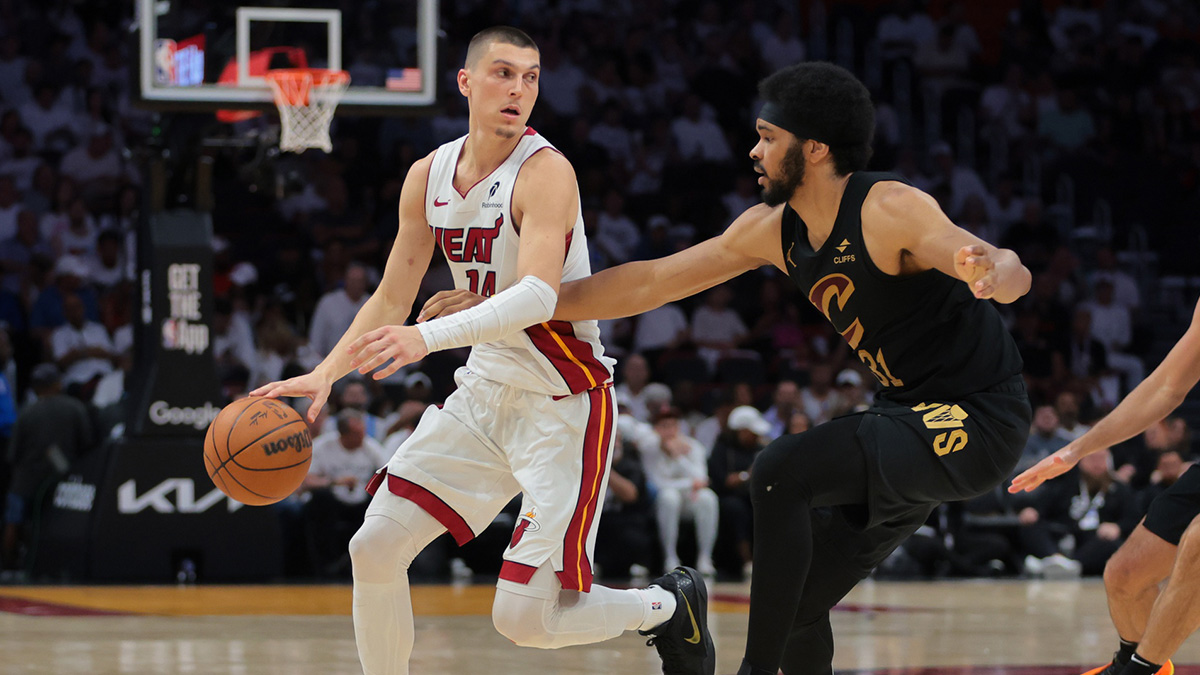 Miami Heat guard Tyler Herro (14) dribbles the basketball as Cleveland Cavaliers center Jarrett Allen (31) defends in the third quarter during game three for the first round of the 2025 NBA Playoffs at Kaseya Center.