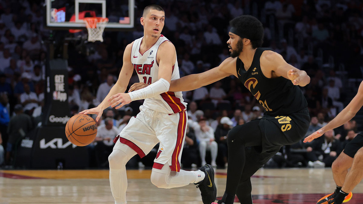 Miami Heat guard Tyler Herro (14) dribbles the basketball as Cleveland Cavaliers center Jarrett Allen (31) defends in the third quarter during game three for the first round of the 2025 NBA Playoffs at Kaseya Center.