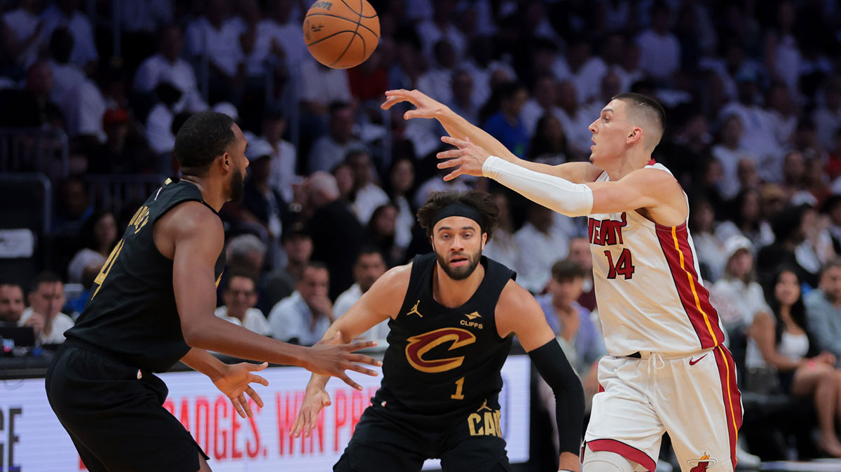 Miami Heat guard Tyler Herro (14) passes the basketball as Cleveland Cavaliers forward Evan Mobley (4) defends in the first quarter during game four for the first round of the 2025 NBA Playoffs at Kaseya Center.
