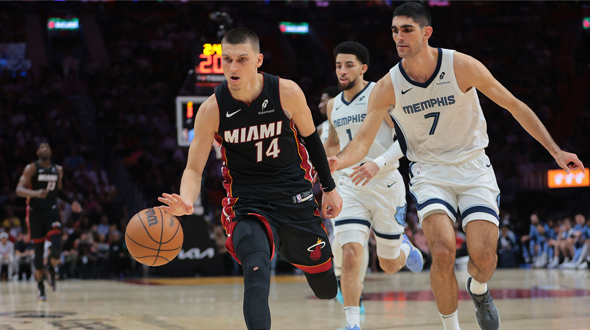Miami Heat guard Tyler Herro (14) dribbles the basketball past Memphis Grizzlies forward Santi Aldama (7) during the fourth quarter at Kaseya Center.
