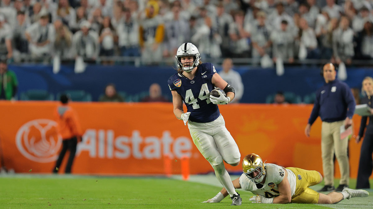 Penn State Nittany Lions tight end Tyler Warren (44) runs passed Notre Dame Fighting Irish defensive lineman Donovan Hinish (41) in the first half in the Orange Bowl at Hard Rock Stadium.