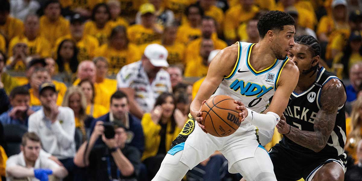 Indiana Pacers guard Tyrese Haliburton (0) dribbles the ball while Milwaukee Bucks guard Kevin Porter Jr. (3) defends during game five of the first round for the 2024 NBA Playoffs at Gainbridge Fieldhouse.