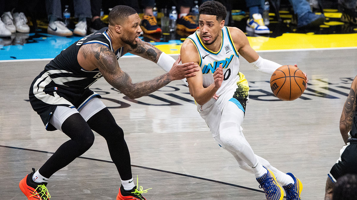 Indiana Pacers guard Tyrese Haliburton (0) dribbles the ball while Milwaukee Bucks guard Damian Lillard (0) defends during game two of first round for the 2024 NBA Playoffs at Gainbridge Fieldhouse.