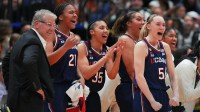 UConn Huskies guard Paige Bueckers (5) reacts with teammates on the bench during the fourth quarter in a semifinal of the women's 2025 NCAA tournament against the UCLA Bruins at Amalie Arena.