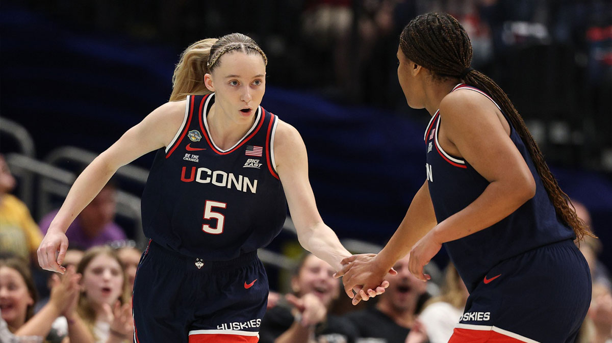 UConn women's basketball guard Paige Bueckers (5) high fives UConn women's basketball forward Sarah Strong (21) during first half in a semifinal of the women's 2025 NCAA tournament against the UCLA Bruins at Amalie Arena.