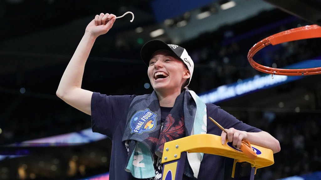 Connecticut Huskies guard Paige Bueckers (5) holds up a piece of the net after the national championship of the women's 2025 NCAA tournament against the South Carolina Gamecocks.