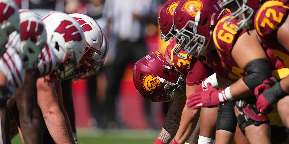 Southern California Trojans and Wisconsin Badgers helmets at the line of scrimmage in the second half at United Airlines Field at Los Angeles Memorial Coliseum. Mandatory Credit: Kirby Lee-Imagn Images