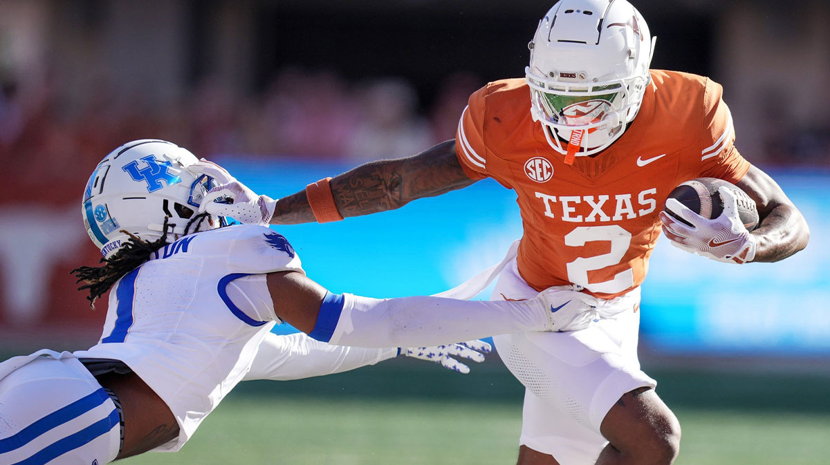 Texas Longhorns wide receiver Matthew Golden (2) stiff arms Kentucky Wildcats defensive back Maxwell Hairston (1) in the first quarter of an NCAA college football game at Darrell K Royal Texas Memorial Stadium in Austin, Texas on Saturday, Nov. 24, 2024.