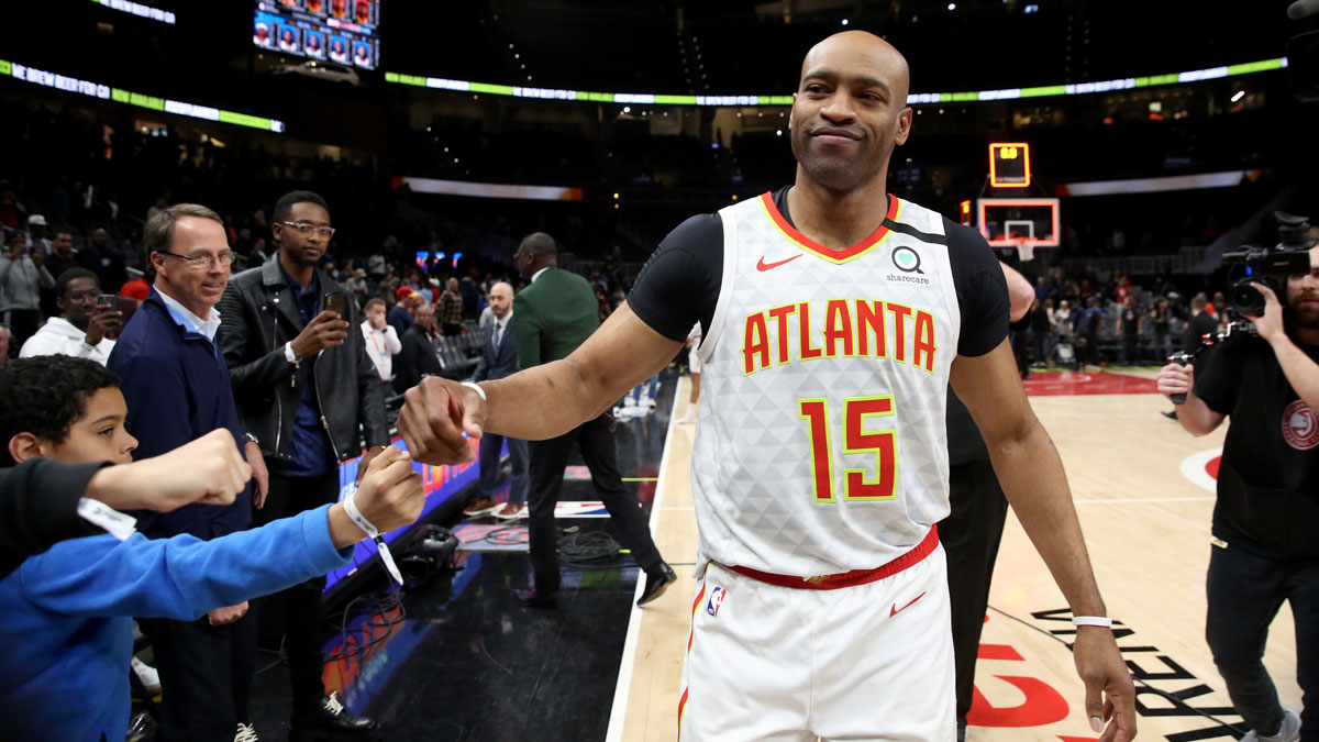 Atlanta Hawks guard Vince Carter (15) fist bumps fans after an overtime loss to the New York Knicks at State Farm Arena.
