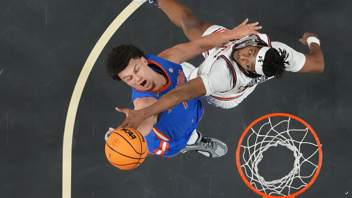 Florida Gators guard Walter Clayton Jr. (1) attempts to shoot against Auburn Tigers forward Chaney Johnson (31) in the semifinals of the men's Final Four of the 2025 NCAA Tournament at the Alamodome. Mandatory Credit: Robert Deutsch-Imagn Images