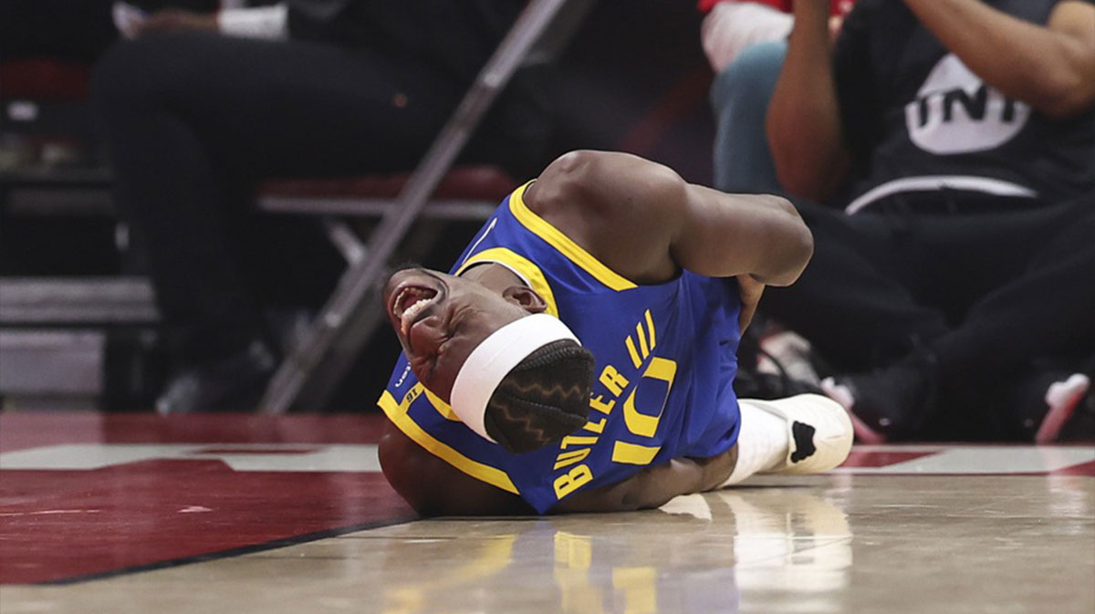 Golden State Warriors forward Jimmy Butler III (10) suffers an apparent injury during the first quarter during game two of the first round for the 2024 NBA Playoffs against the Houston Rockets at Toyota Center.