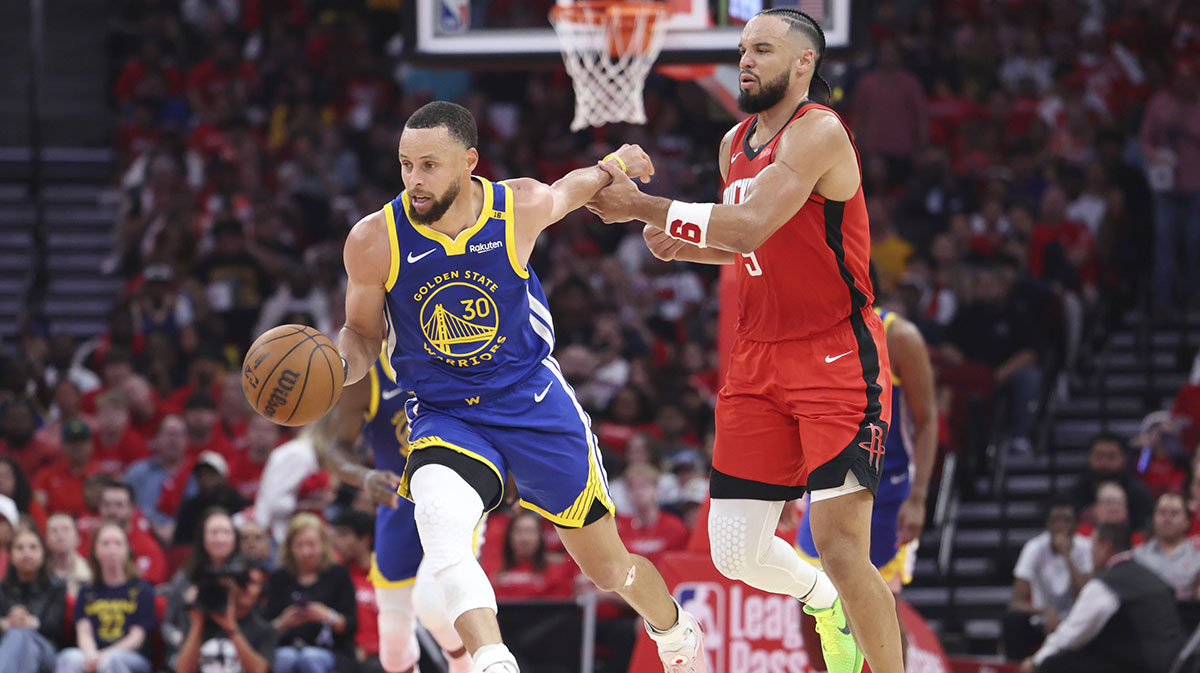 Golden State Warriors guard Stephen Curry (30) controls the ball as Houston Rockets forward Dillon Brooks (9) defends during the second quarter at Toyota Center.