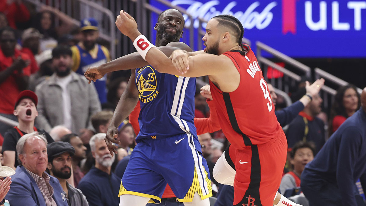 Warriors forward Draymond Green (23) and Houston Rockets forward Dillon Brooks (9) tangle arms