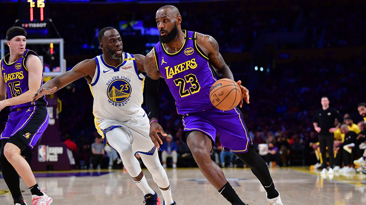  Los Angeles Lakers forward LeBron James (23) moves the ball against Golden State Warriors forward Draymond Green (23) during the first half at Crypto.com Arena. 