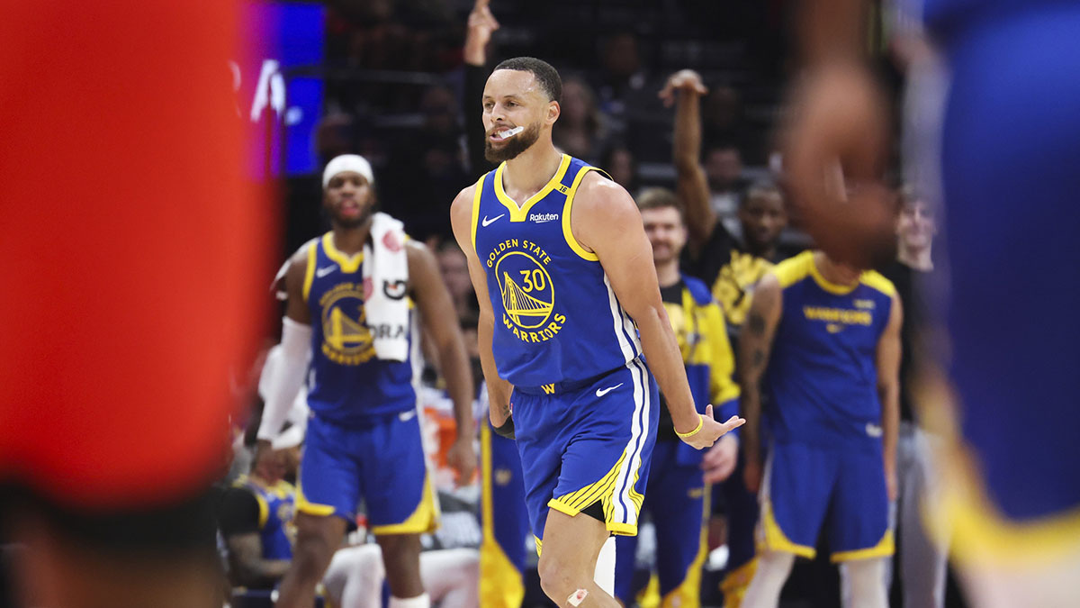 Warriors guard Stephen Curry (30) reacts after making a basket