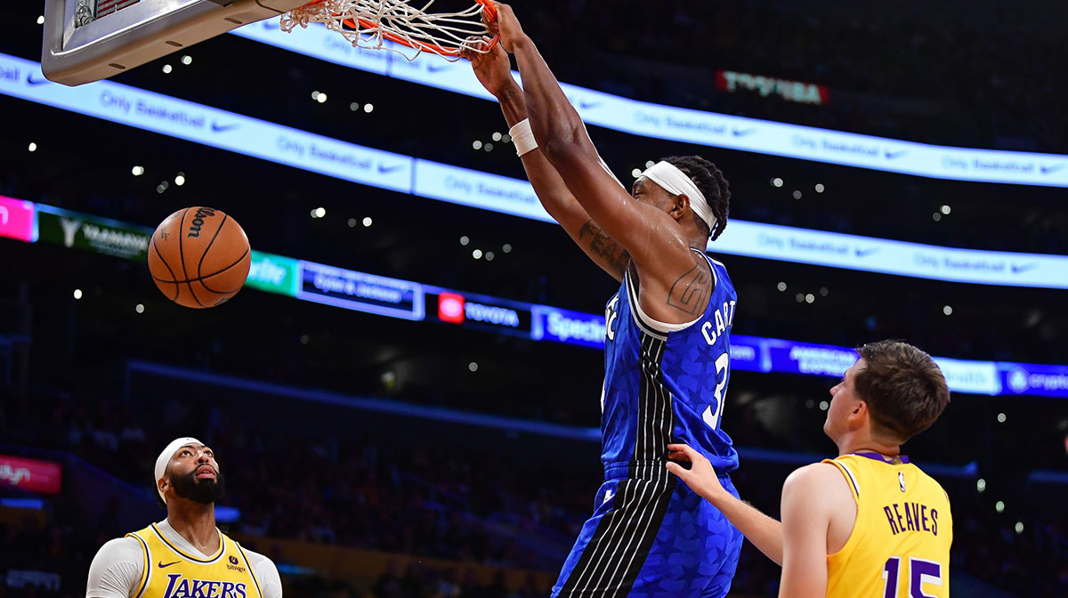 Orlando Magic center Wendell Carter Jr. (34) dunks for the basket against Los Angeles Lakers forward Anthony Davis (3) and guard Austin Reaves (15) during the first half at Crypto.com Arena.