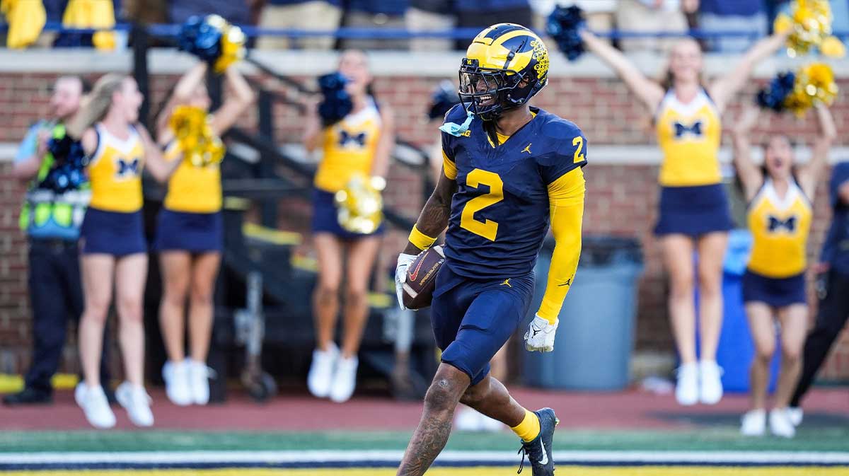 Michigan defensive back Will Johnson celebrates a touchdown after intercepting USC quarterback Miller Moss during the second half at Michigan Stadium