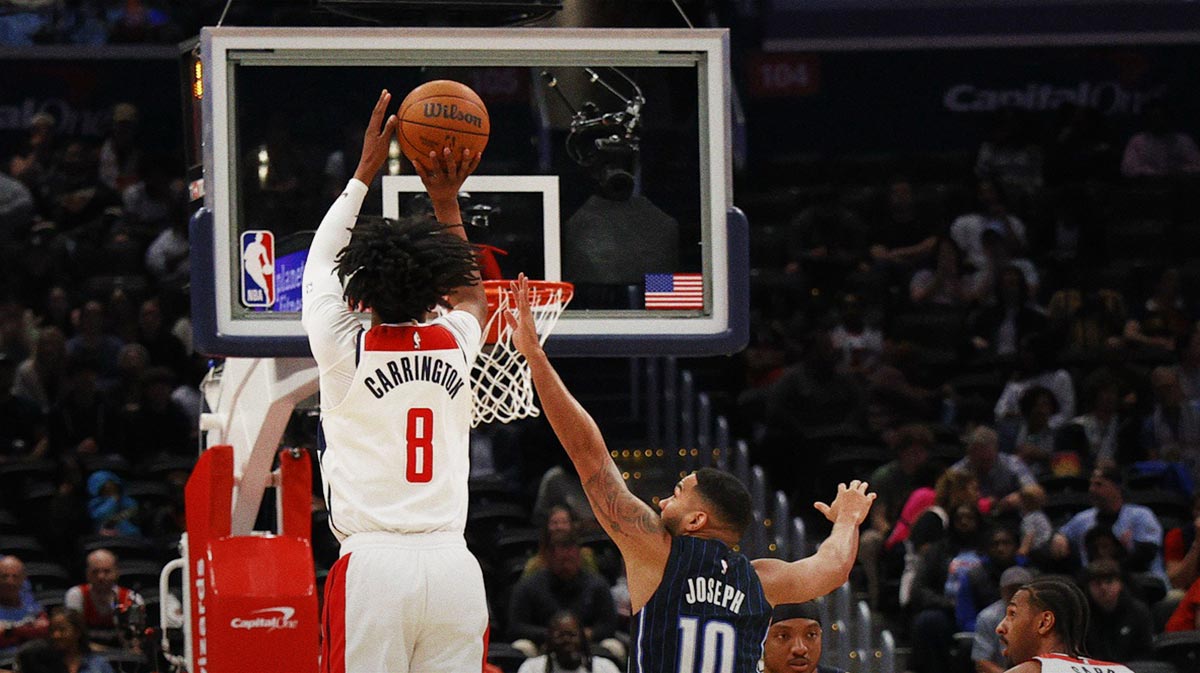 Washington Wizards guard Bub Carrington (8) shoots the ball as Orlando Magic guard Cory Joseph (10) defends in the first half at Capital One Arena.