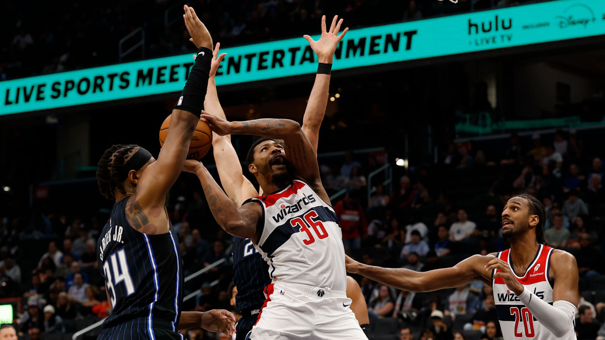 Washington Wizards guard Marcus Smart (36) is fouled while shooting by Orlando Magic forward Franz Wagner (22) in the second half at Capital One Arena.