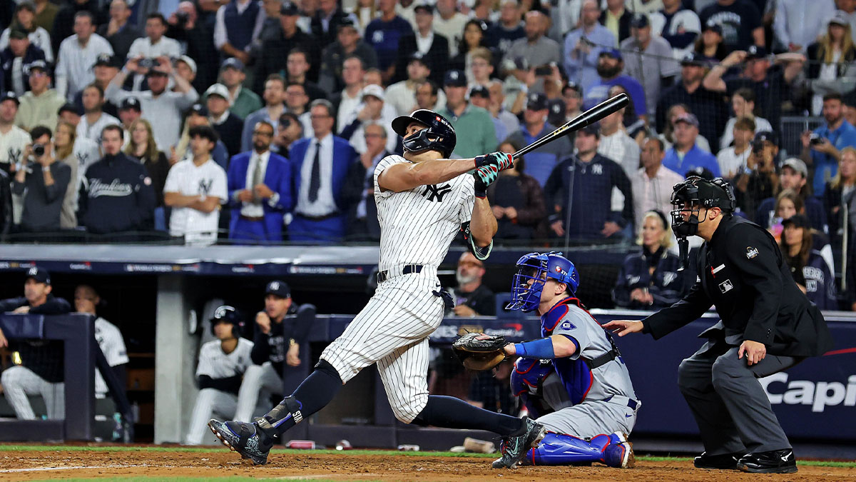 New York Yankees designated hitter Giancarlo Stanton (27) hits an RBI sacrifice fly during the sixth inning against the Los Angeles Dodgers in game four of the 2024 MLB World Series at Yankee Stadium.