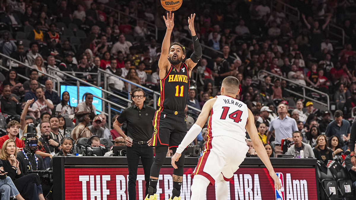 Atlanta Hawks guard Trae Young (11) shoots over Miami Heat guard Tyler Herro (14) during the first half at State Farm Arena