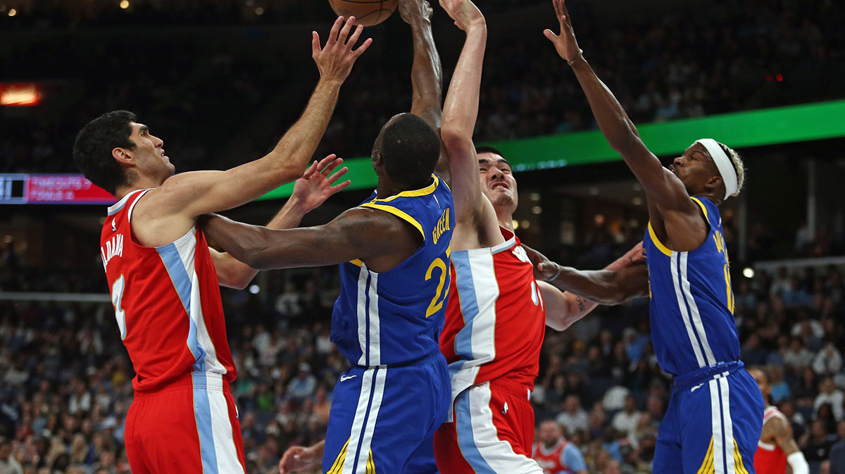 Memphis Grizzlies forward Santi Aldama (left), Golden State Warriors forward Draymond Green (left middle), Memphis Grizzlies center Zach Edey (right middle), and Golden State Warriors forward Jimmy Butler III (10) battle for a rebound during the first quarter at FedExForum.
