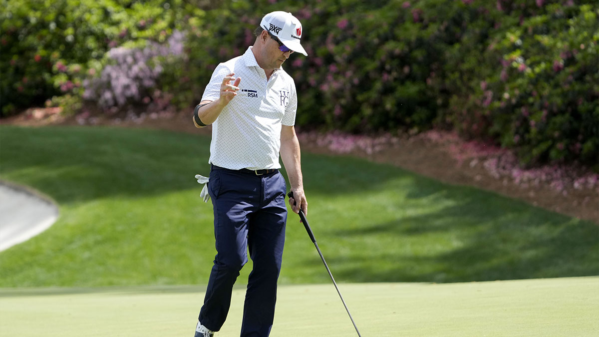 Zach Johnson waves to patrons from the no. 13 green during the second round of the Masters Tournament at Augusta National Golf Club.