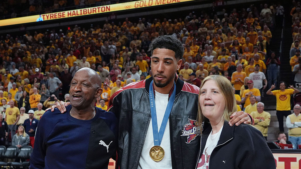 Pacers guard Tyrese Haliburton holds his parents John and Brenda Haliburton