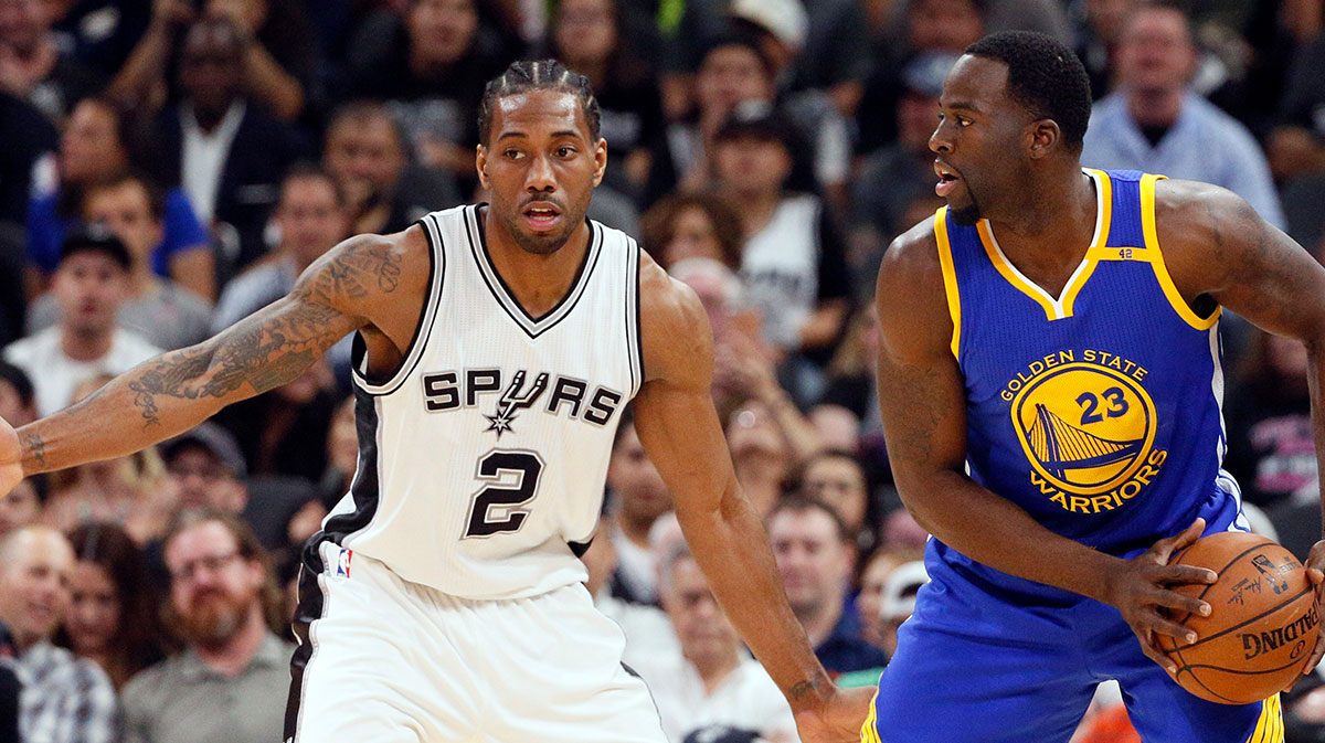 Golden State Warriors power forward Draymond Green (23) looks to pass the ball as San Antonio Spurs small forward Kawhi Leonard (2) defends during the first half at AT&T Center.