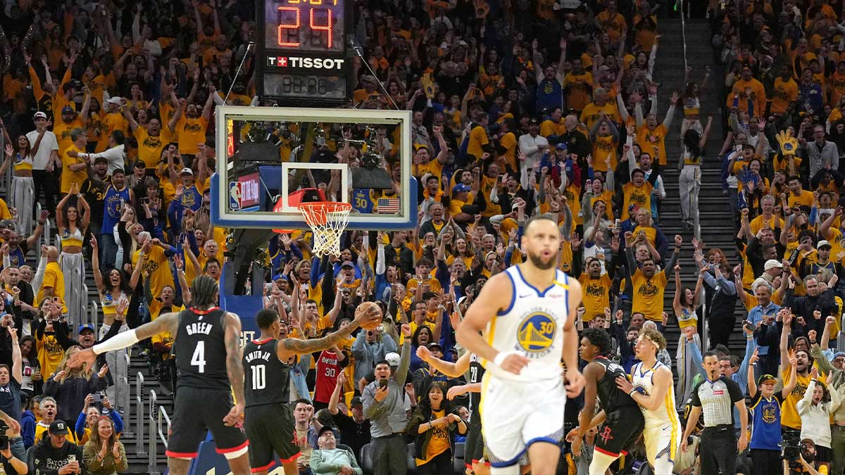 Golden State Warriors fans react after a three-point basket by guard Stephen Curry (foreground) against the Houston Rockets during the fourth quarter of game three of first round for the 2024 NBA Playoffs at Chase Center.