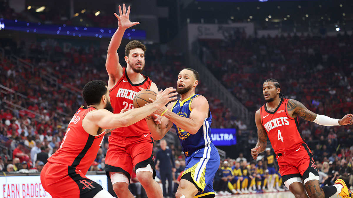 Rockets guard Fred VanVleet (5) and center Alperen Sengun (28) defend against Golden State Warriors guard Stephen Curry (30)